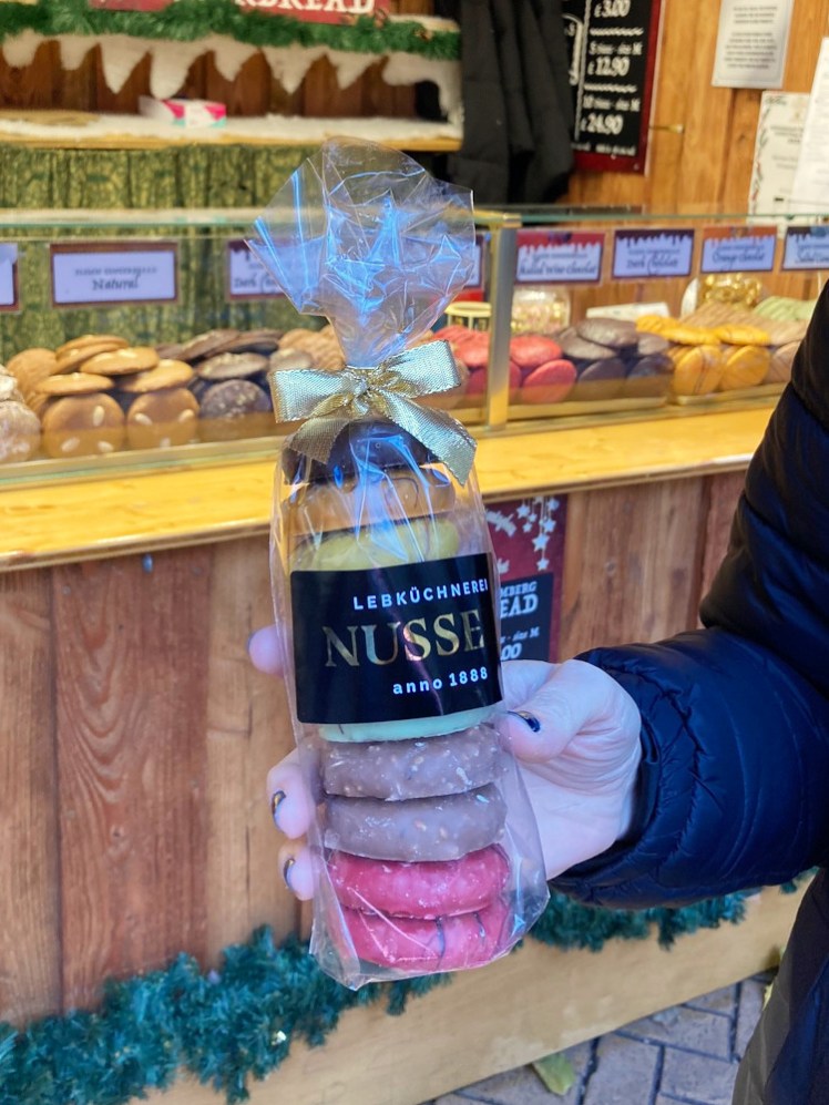 A bag of ten assorted small gingerbread biscuits, all iced in different colours and tied up with a gold bow.
