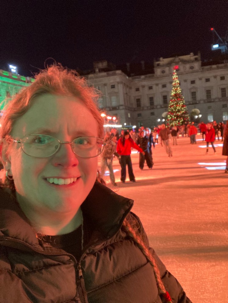 A selfie on the ice at Somerset House. It's all illuminated in very un-icy orange.