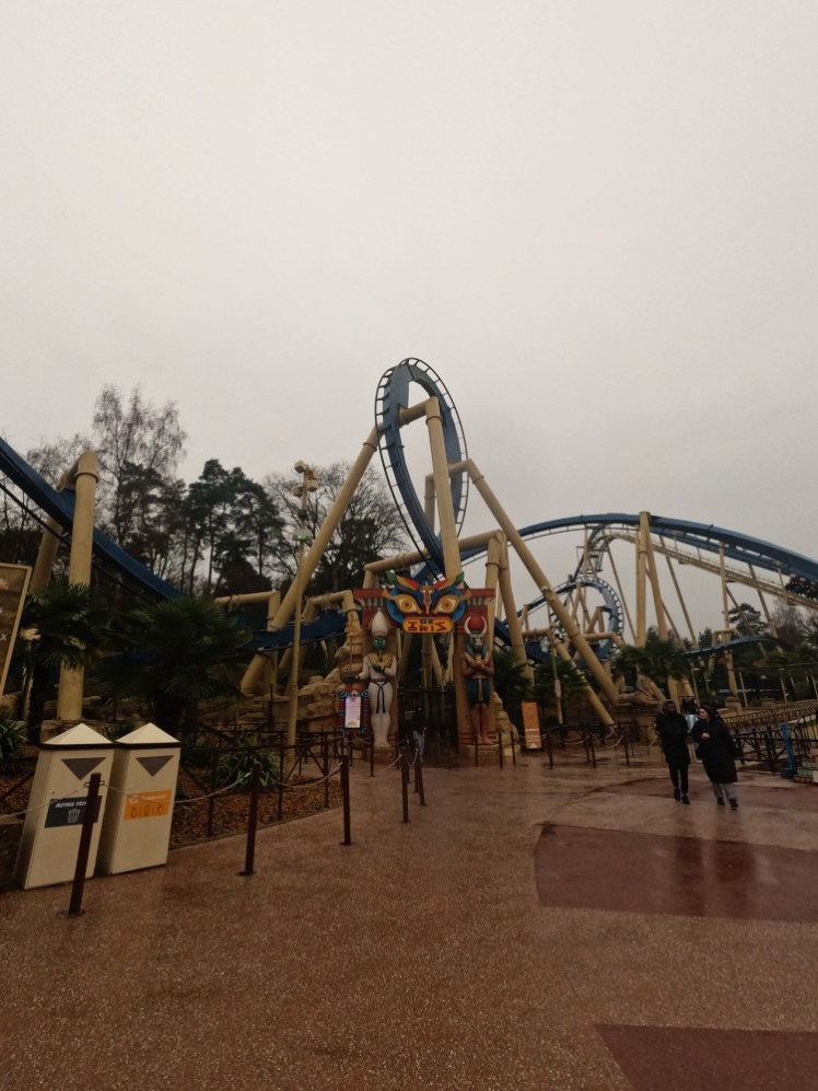 OzIris in the rain, with Egyptian figures and hieroglyphs over the entrance and steel loops rising up over Ancient Egypt.