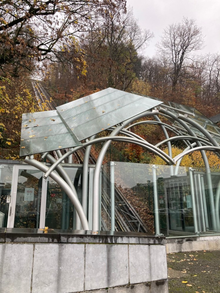 The funicular that goes up to the therme on top of the hill at Spa. It has slanted glass roofs over where the car would be if there was one but there isn't.
