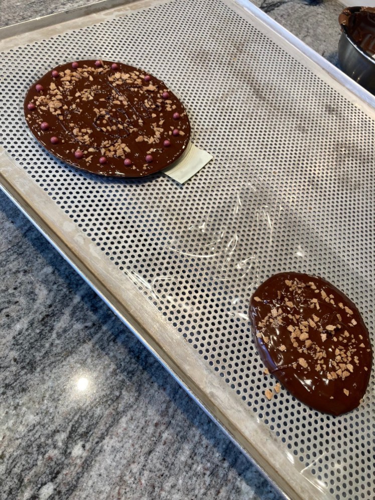 My two chocolate bars on the cooling rack. The real one is on the left and the leftover chocolate dollop is to the right, and it's not a whole lot smaller than the real thing, although it's a lot less neat.