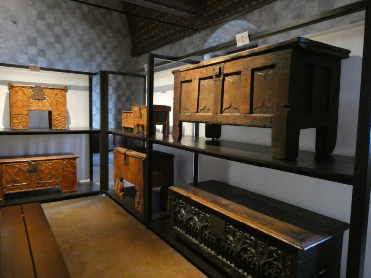 Shelves packed with medieval wooden chests and boxes which would once have carried all Savoy's furniture.