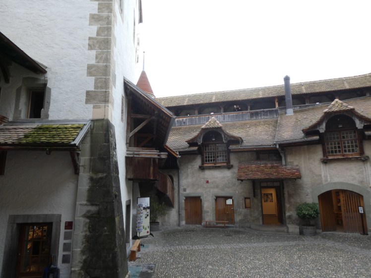 The first courtyard where ramparts overlook the buildings that make up the sides of the courtyard. The building to the left is actually the gift shop these days.