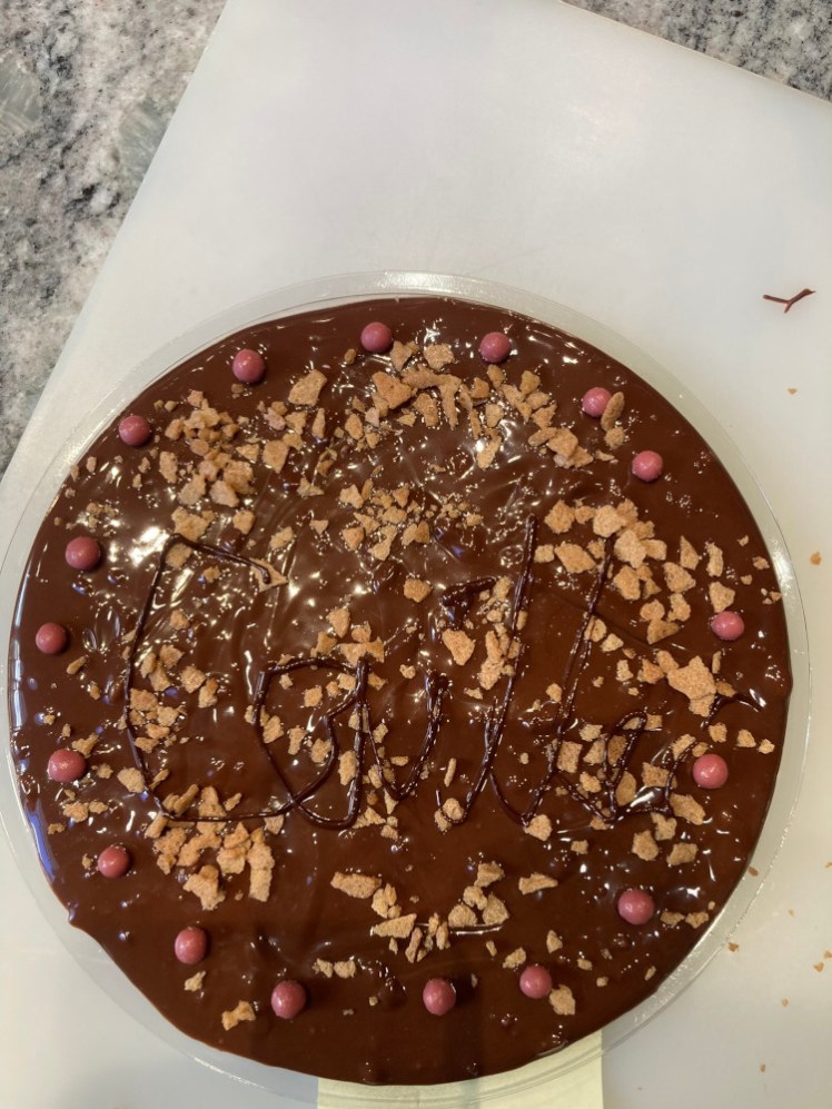 My finished chocolate bar in its mould, poured, decorated and piped but still liquid.