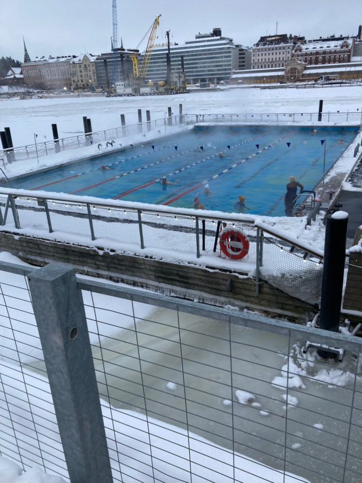 The geothermal pool from just above, with people swimming.