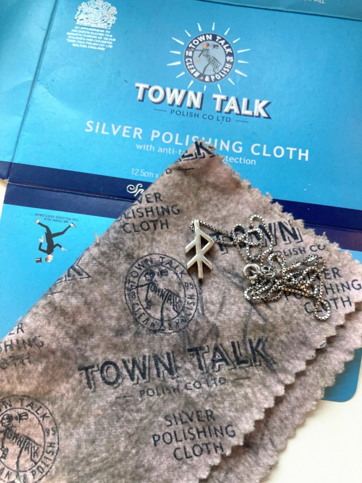 The same bindrune lying on a very blackened, once pink, cloth. The black is polish, so it's meant to look like this but it is getting past its best by now.