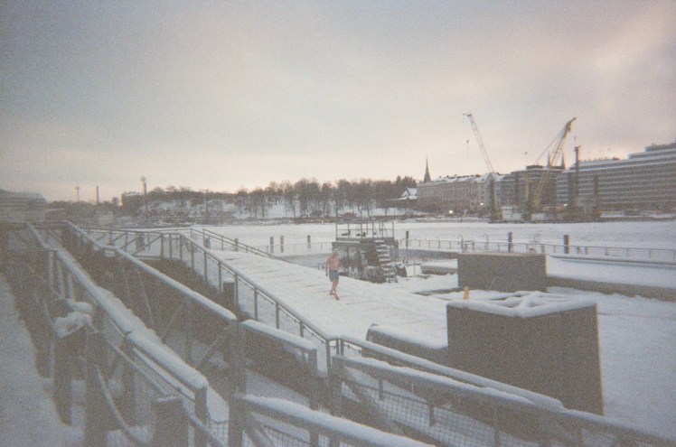 Allas Sea Pool, a geothermal pool in a wooden deck floating in the frozen harbour.