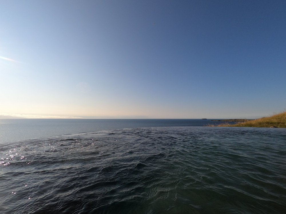 The infinity edge of the pool seeming to flow into the fjord which is actually a long way down the cliff but from this angle just seems to continue from Geosea's pool.