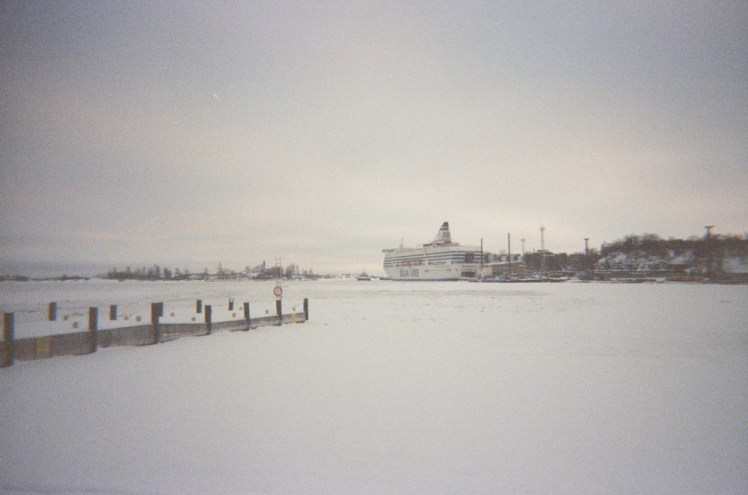 Helsinki's harbour, an expanse of almost entirely undisturbed ice with a cross-Baltic ferry in the distance.