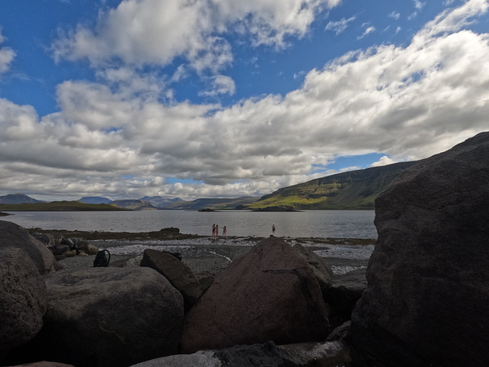 The view from one of the pools down to the beach on a warm summer day with people coming out of the fjord after a jellyfish-infested swim.