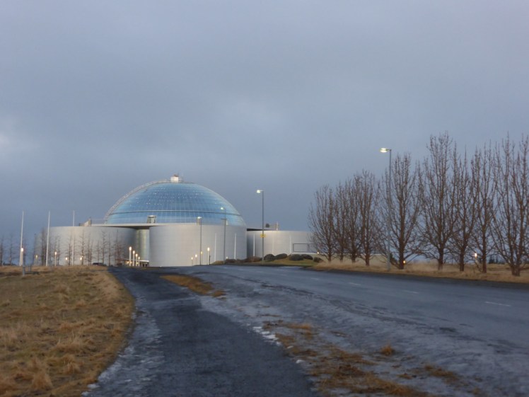 Perlan, a glass half-sphere sitting on top of six silvery tanks. It's on top of a hill which looks a bit the worse for being winter.