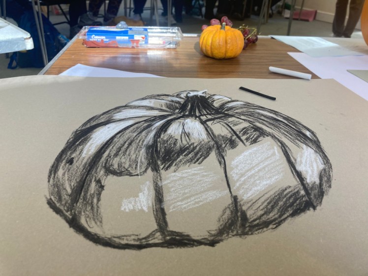 A sketch in charcoal and chalk of a pumpkin during our autumn vegetable still life drawing class.