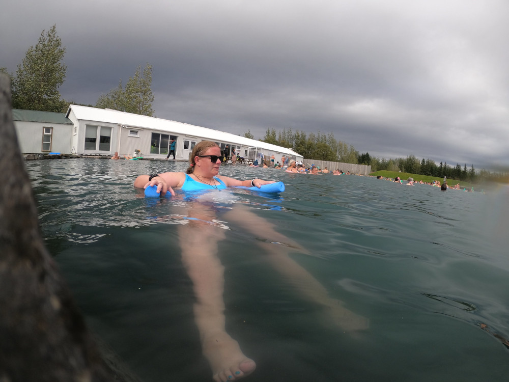 A selfie floating on a pool noodle, with the water refraction making my legs look incredibly long.