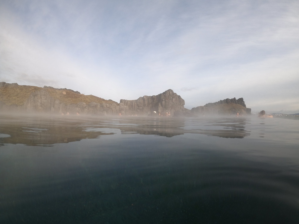 A view across the pool to the other cliffs on a misty day.