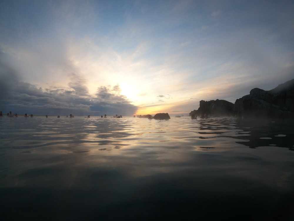 The sun setting over the Sky Lagoon, reflecting over the infinity pool.