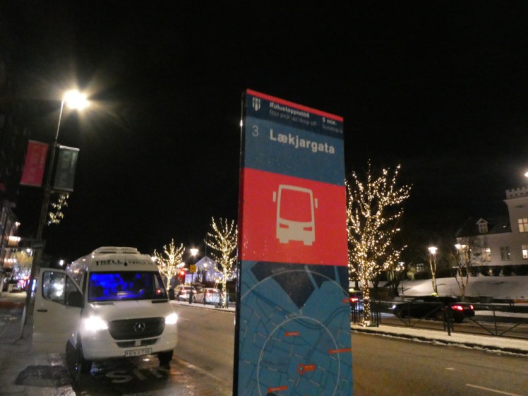 A tourist bus stop marker - they're bright blue with a brighter pink band around the top. They're numbered and named and underneath there's a map showing where the bus stop actually is and where the closest other bus stops are.