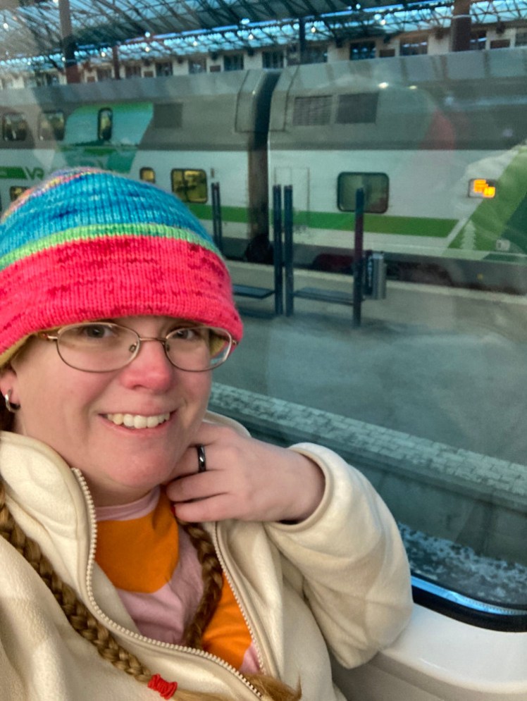 A selfie upstairs in the train with the station platform below me, although I admit it's not quite so obvious in the photo. I'm wearing my colourful Musselburgh hat, an off-white Marimekko fleece and my pink and orange scallop-striped Marimekko t-shirt.