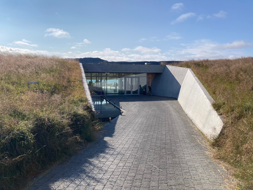 The entrance to Vok Baths, set in a turf building that just looks like a grass bank.