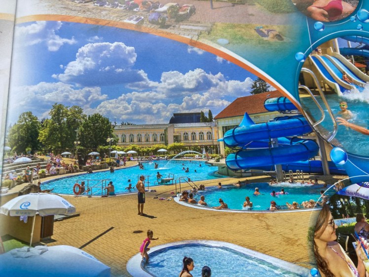 Another picture from the brochure, this time of the outside area in the summer, the pools vivid blue against the beach-yellow of the soft surfacing around them.