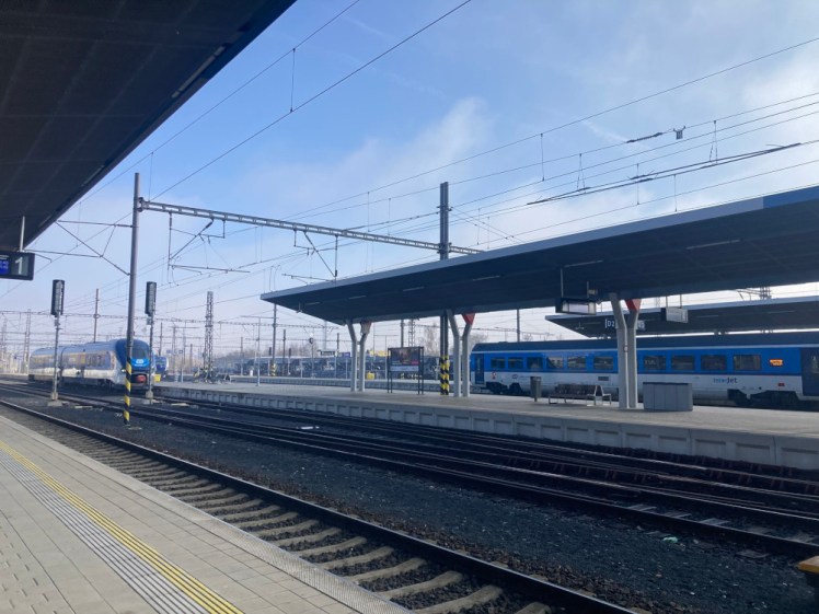 The station at Cheb, with various sleek modern blue Czech trains coming in and waiting at the platform.