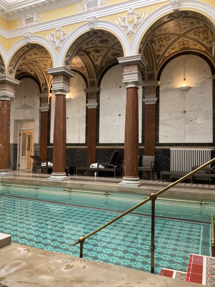 The bath itself. It has brass rails and a tiled bottom and is absolutely still because everyone's lying on the loungers right now.