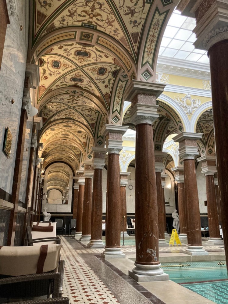 The Roman baths chamber. You can see the water in the bottom right corner but mostly this picture shows the marble columns and the decorative ceiling.
