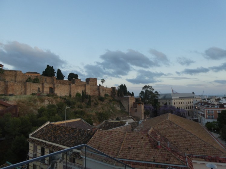 The Alcazaba walls as seen from a rooftop bar towards the end of the day as the sun descends opposite.