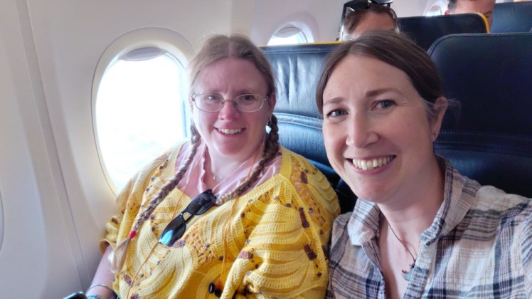 Me and Catherine on the plane, waiting to take off. I'm wearing a crochet banana jumper over a pale pink t-shirt and Catherine is wearing a blue and white checked shirt.