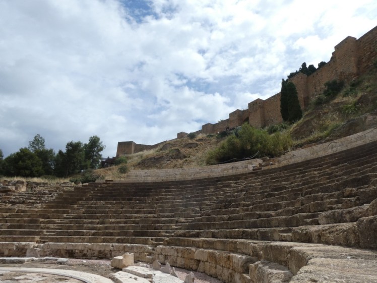 The Roman theatre as seen from stage right with the walls of the Alcazaba rising up above the seating.