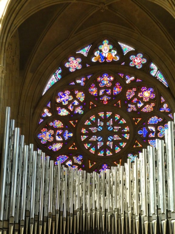 The big rose window in the west end, featuring enough blues and reds to make it look quite purple from a distance, looming over the organ pipes.
