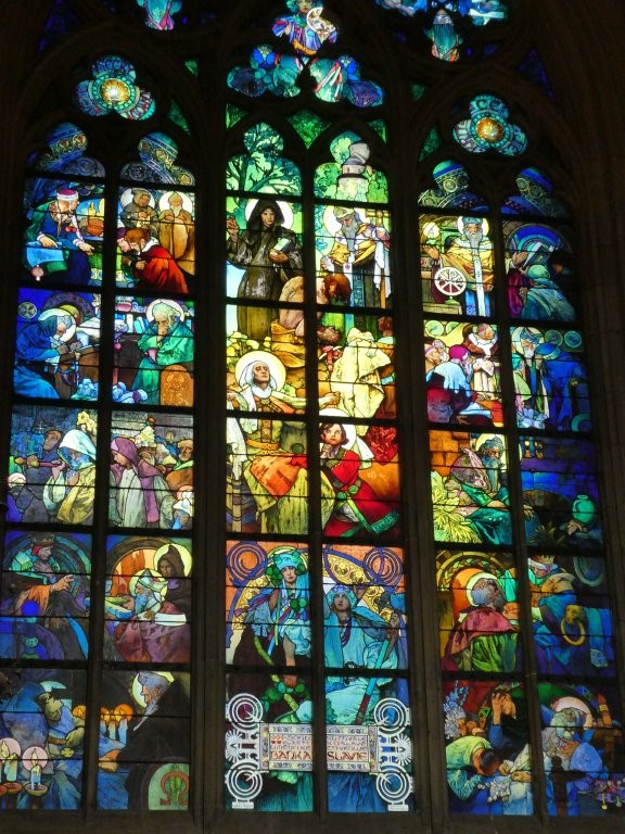 A modern window that looks a little more traditional, other than that the centre glows green and the edges blue, featuring scenes from the Bible.