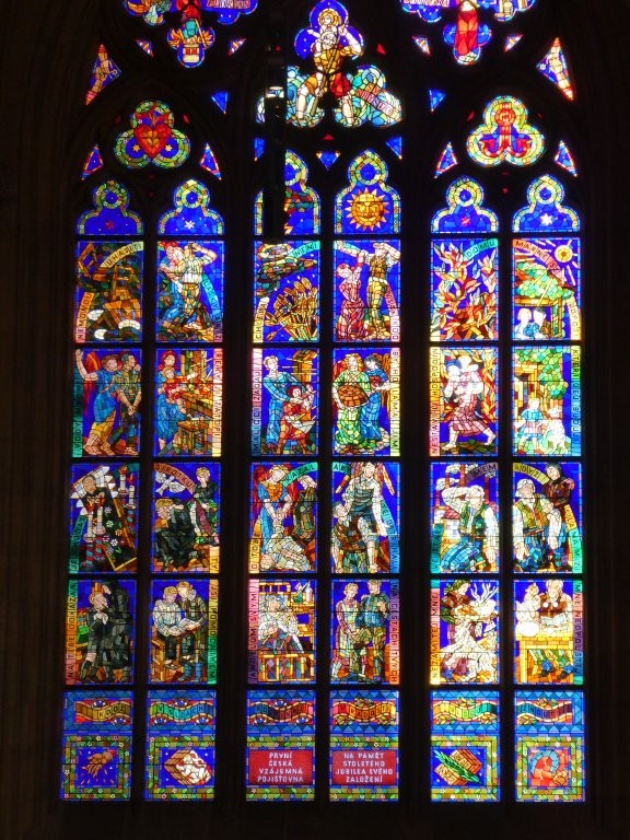 A window mostly in shades of blue, again with separate figures in every compartment, and again, mosaic-style. They each have a label either up the side or arcing across and these labels are in pastel rainbows.