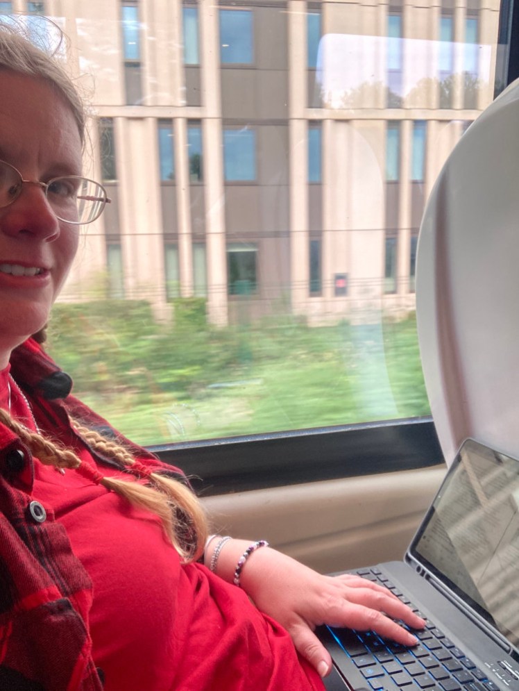 A selfie on the train to Bournemouth, with my tablet out on the table, writing this blog.