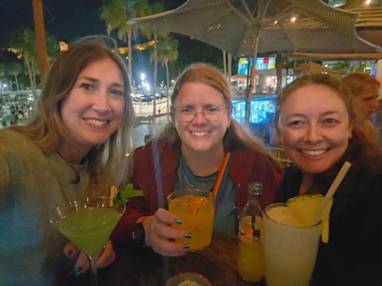 The three of us at the harbourside Nusa cocktail bar, each with our colourful drinks.