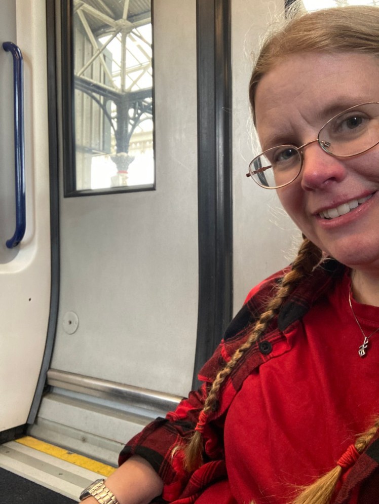 A selfie sitting on the floor by the door on the train from York to Scarborough.