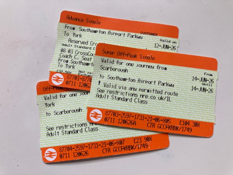 A pile of train tickets - the one from Southampton to York is for a specific seat on a specific train but the ticket back is simply for Scarborough to Southampton by any permitted route.