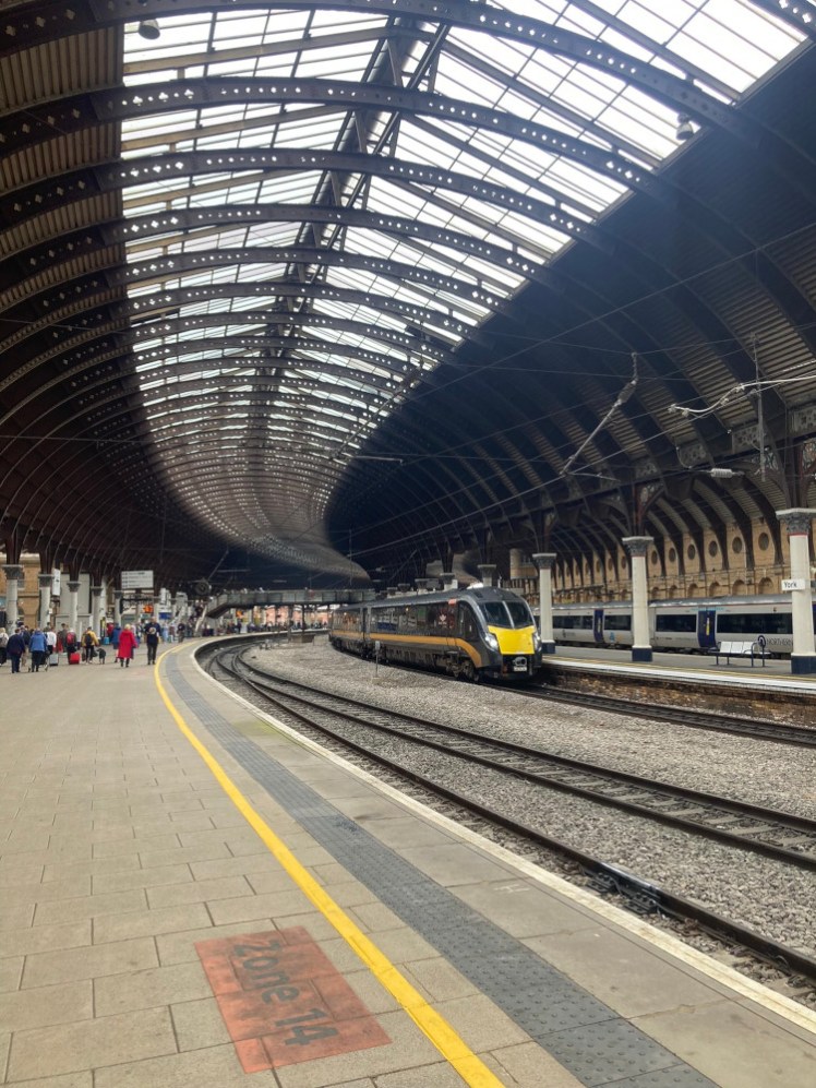 York station, slightly curved and with a wrought iron roof over it.