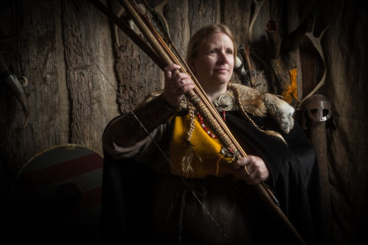 Me looking very serious with an armful of weapons, including halberds, a bow and the arrows.