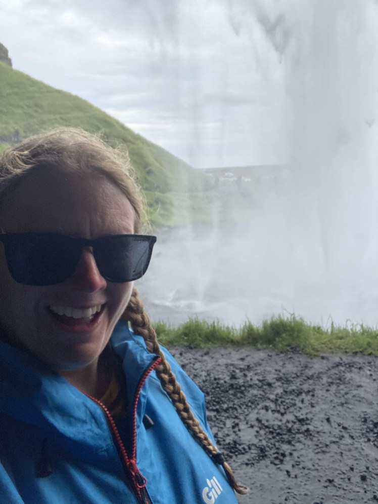 Me in a cave standing behind the waterfall, which pretty much forms a wall of water.