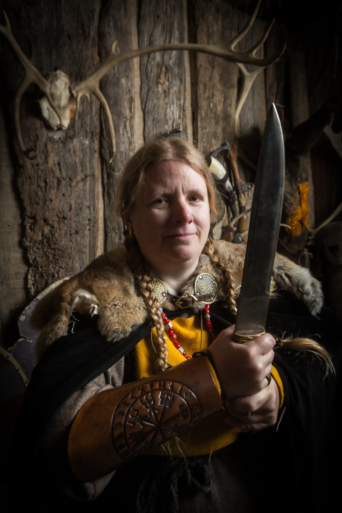 Trying to look vaguely threateningly at the camera while holding a very large knife.