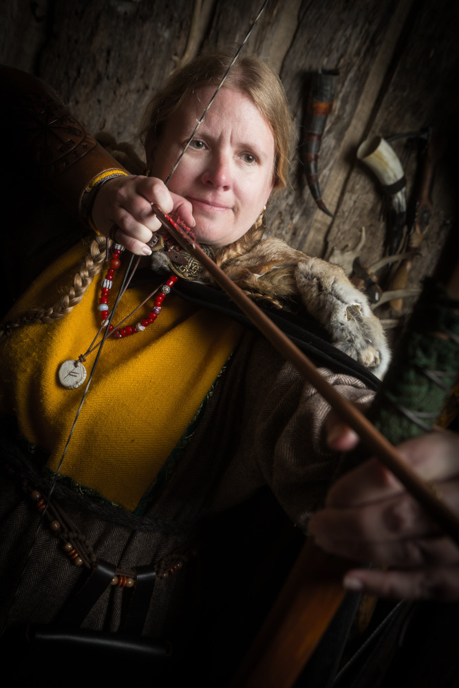 Aiming an arrow with a proper longbow. It kills me that the arrow is on the wrong side of the bow.