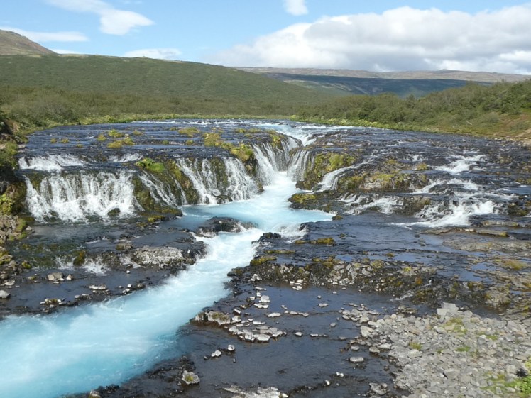 Bruarfoss, a waterfall in the middle of its own river, where a sudden drop in the level of the bottom of the river forms a waterfall. The river then flows into a chasm in the middle of the new, lower river level.