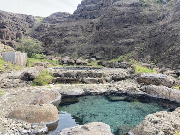The Canyon Baths, two mostly-circular pools surrounded by stones set in a canyon with a nice stratified wall.
