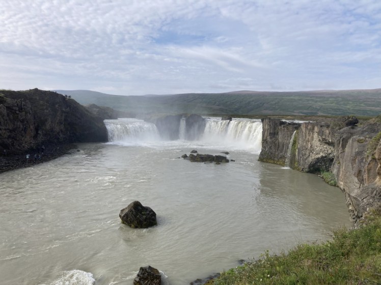 Godafoss on a nice morning, a horseshoe waterfall broken up by bits of rock that turn it into multiple smaller waterfalls.