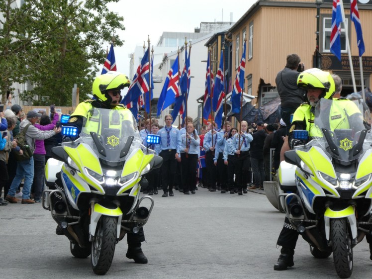 The Independence Day parade, heralded by two police on motorbikes and led by Scouts in smart uniform with flags.