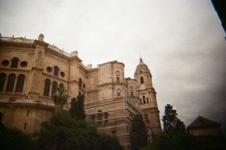 Malaga cathedral from the east side, with a great round side and a tower.