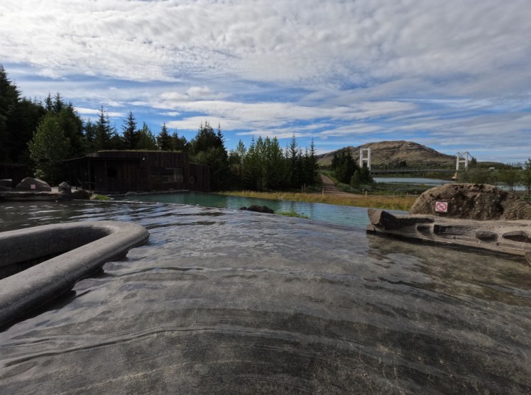 A view from the upper lagoon, with the steps to the left, looking over the lower lagoon and out to the river and bridge.