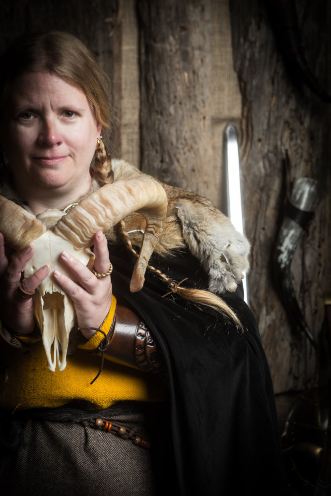Off-centre, looking peaceful with a horned sheep's skull in my hands.