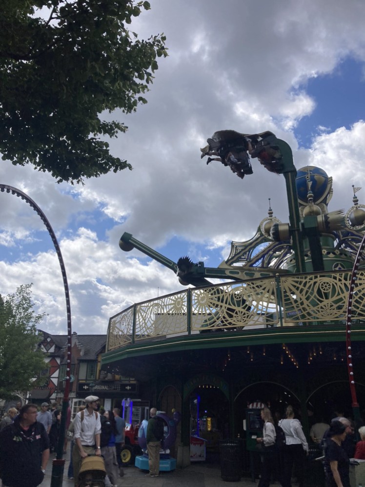 Aquila, which looks like just a kind of carousel, except that as it spins, each arm spins the seats. In this picture, I've caught one of them upside down so the riders are literally hanging like ragdolls.