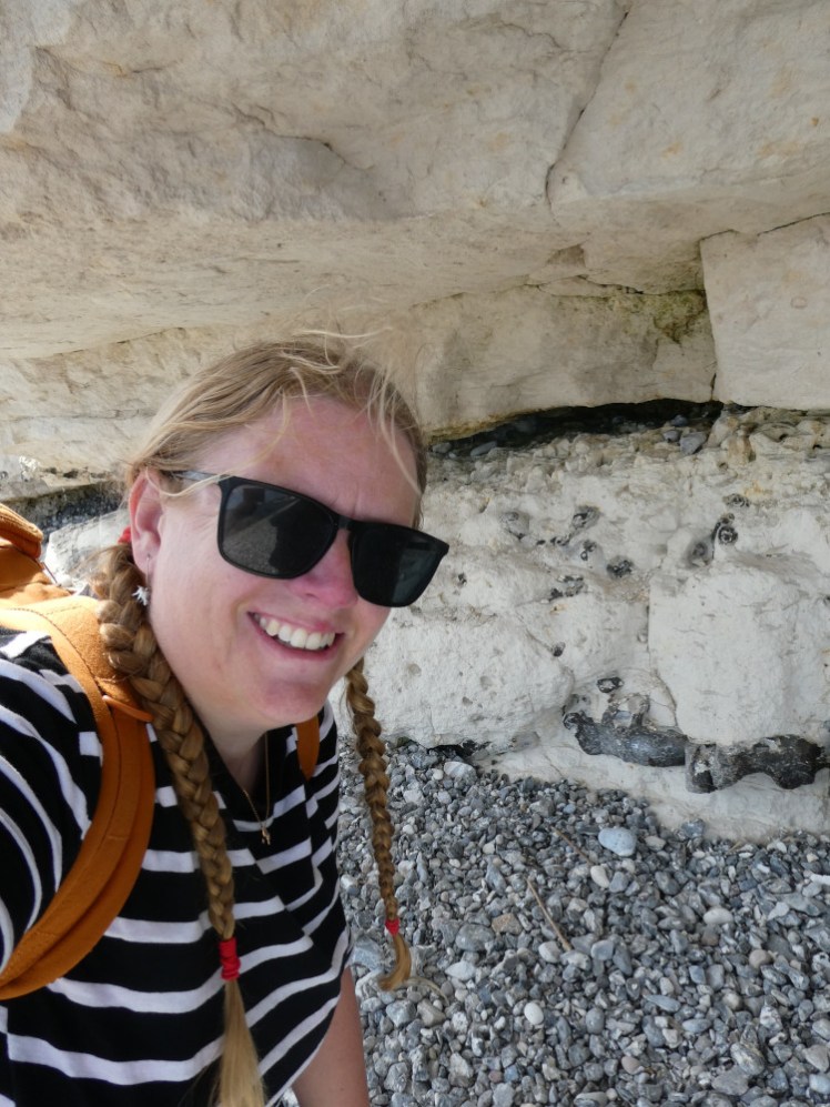 A selfie under the overhanging cliff with the layer of fish clay.